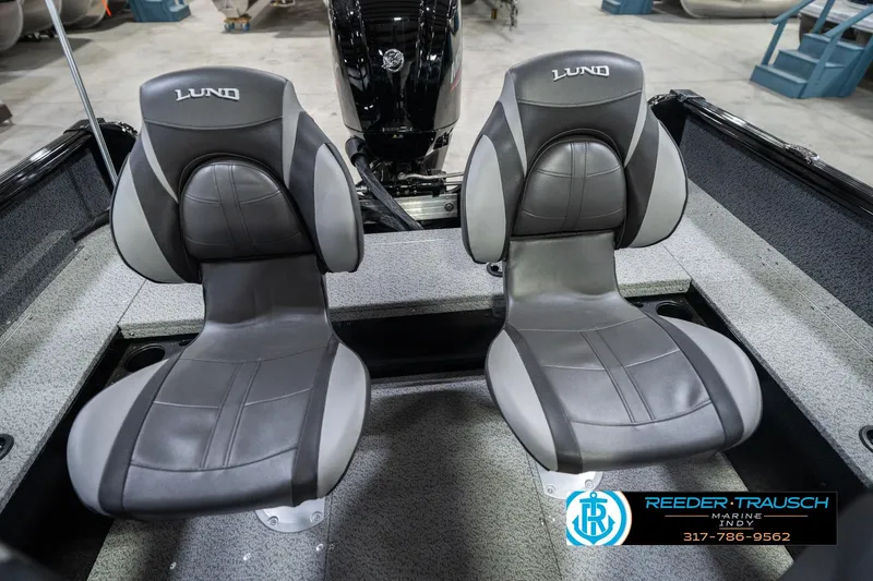 Slide: The Image of 2026 Lund 1700 Explorer SS boat seats, gray and black, in showroom setting. - 41