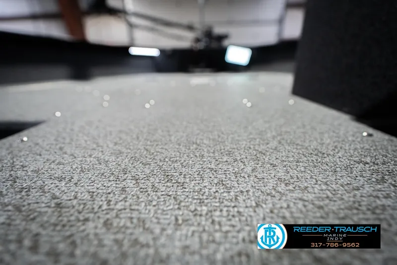 Slide: The Image of 2026 Lund 1700 Explorer SS boat interior with textured flooring, Reeder-Trausch Marine logo visible. - 43