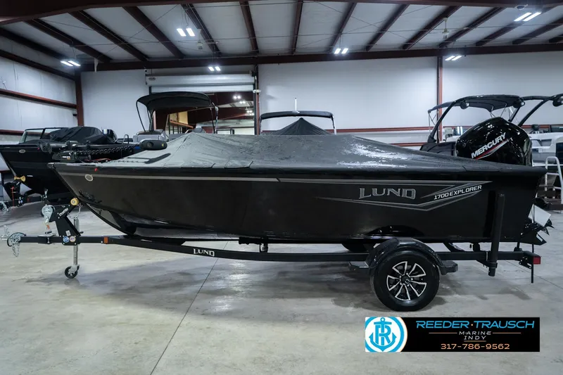 Slide: The Image of 2026 Lund 1700 Explorer SS boat in showroom, covered and on trailer. - 65