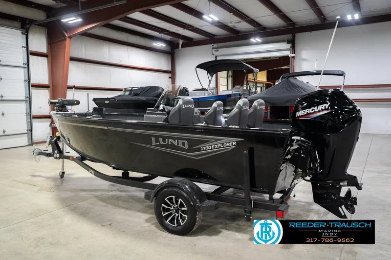 Slide: The Image of 2026 Lund 1700 Explorer SS boat in showroom with Mercury engine. - 9
