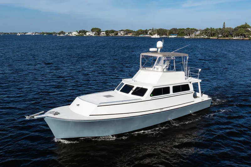 Slide: The Image of 2014 Chesapeake 46 Trawler cruising on a calm blue sea under a clear sky. - 1