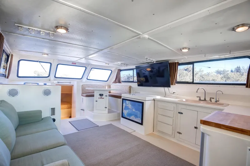 Slide: The Image of Interior of 2014 Chesapeake 46 Trawler with modern amenities and large windows. - 11
