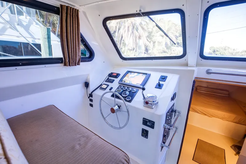 Slide: The Image of 2014 Chesapeake 46 Trawler helm with navigation controls and cozy cabin interior. - 12