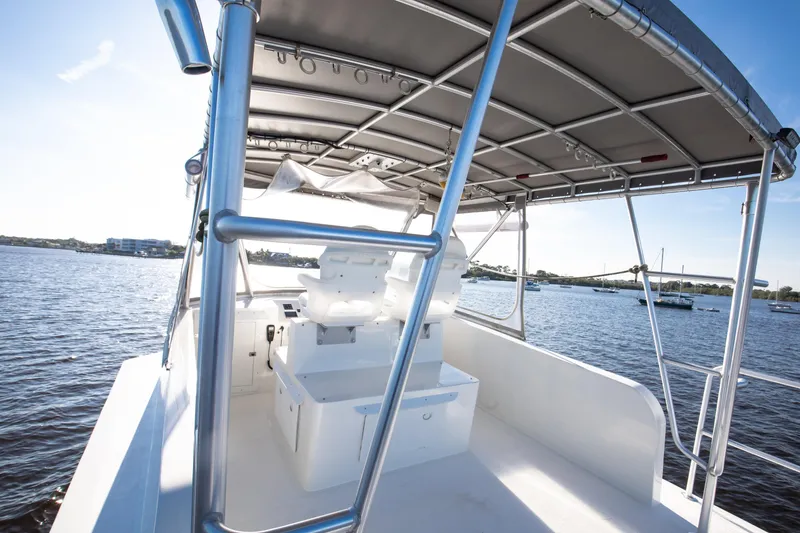 Slide: The Image of 2014 Chesapeake 46 Trawler helm with canopy, overlooking serene waters. - 19