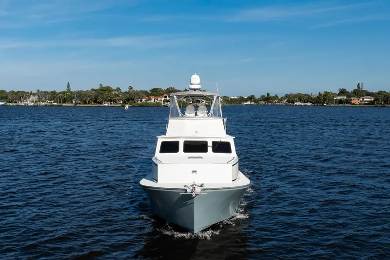 Slide: The Image of 2014 Chesapeake 46 Trawler cruising on a calm blue lake under a clear sky. - 33