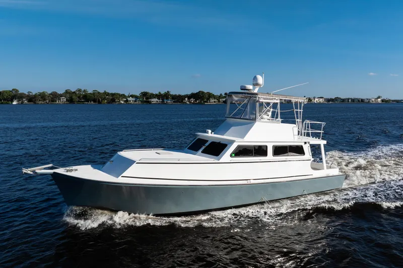 Slide: The Image of 2014 Chesapeake 46 Trawler cruising on a sunny day, with a clear blue sky and calm waters. - 36