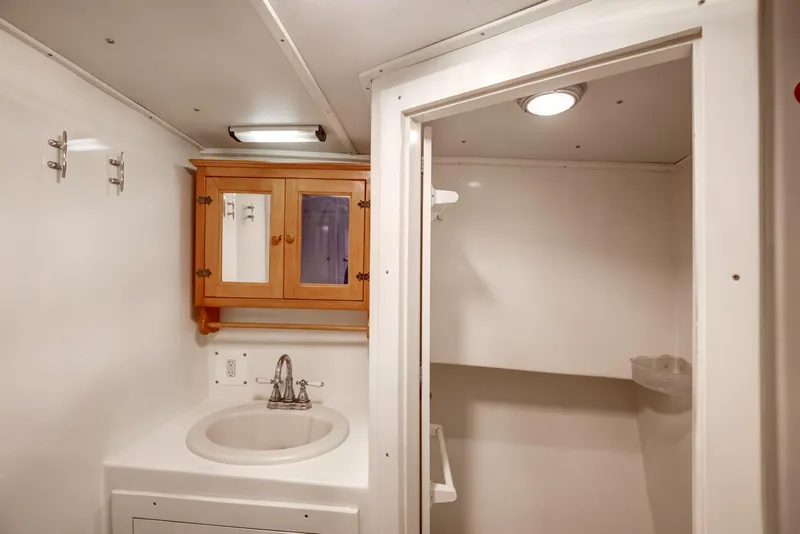 Slide: The Image of Bathroom interior of 2014 Chesapeake 46 Trawler with wooden cabinet and sink. - 7