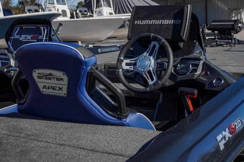 Slide: The Image of 2021 Skeeter FXR20 Apex boat interior with steering wheel and seats. - 12