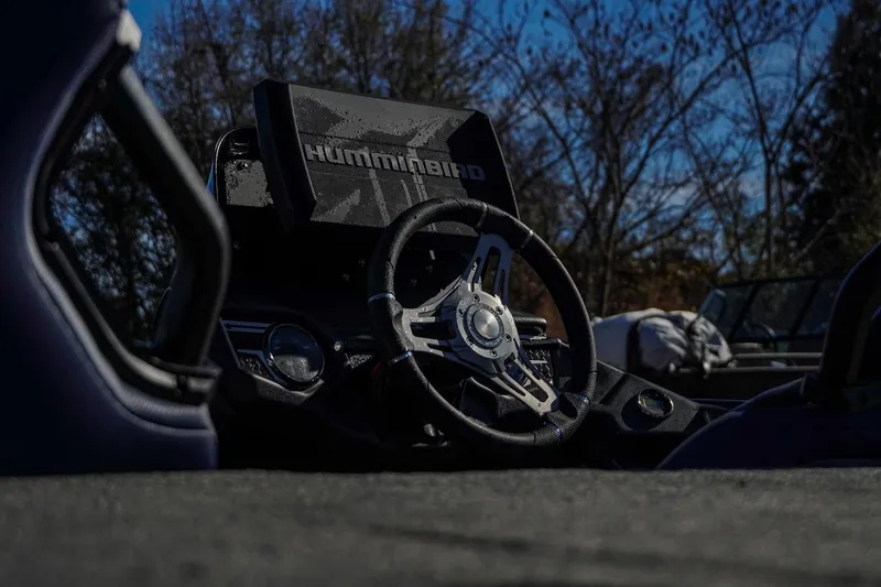 Slide: The Image of 2021 Skeeter FXR20 Apex boat dashboard with Humminbird electronics and steering wheel. - 13