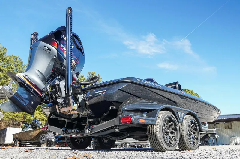 Slide: The Image of 2021 Skeeter FXR20 Apex boat on trailer, showcasing powerful outboard motor and sleek design. - 20