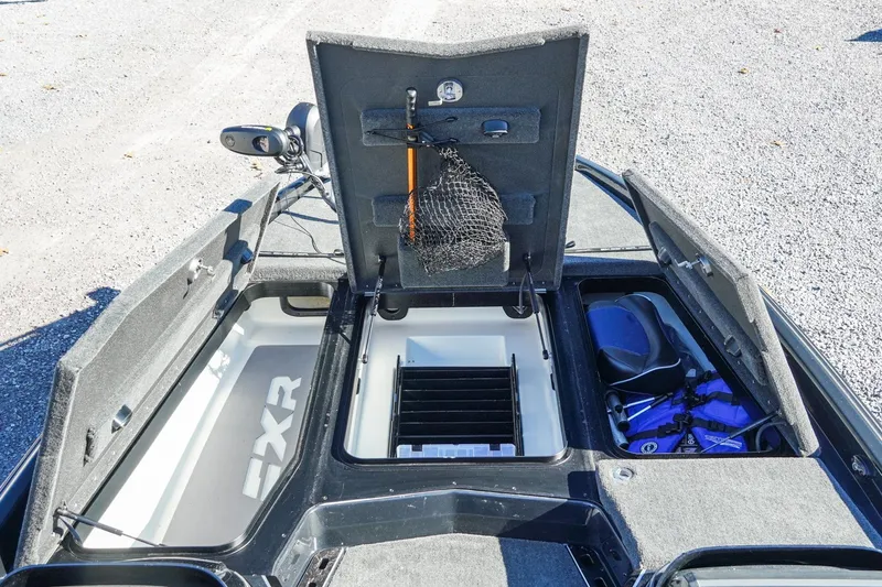 Slide: The Image of 2021 Skeeter FXR20 Apex boat storage compartments with fishing gear and equipment. - 21