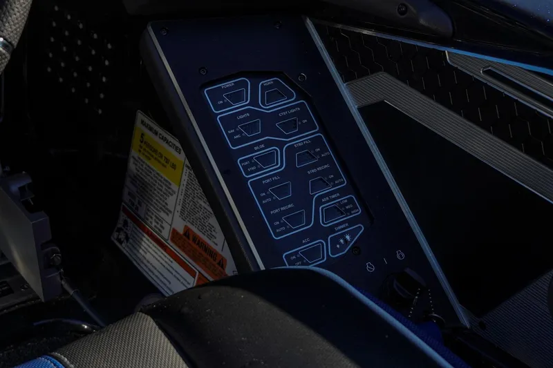 Slide: The Image of Control panel of 2021 Skeeter FXR20 Apex boat with various switches and labels. - 24