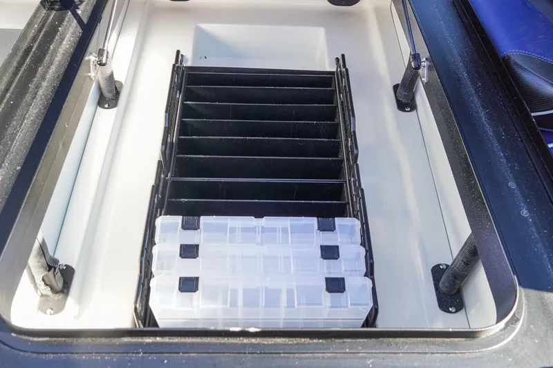 Slide: The Image of 2021 Skeeter FXR20 Apex boat storage compartment with organized tackle boxes. - 25