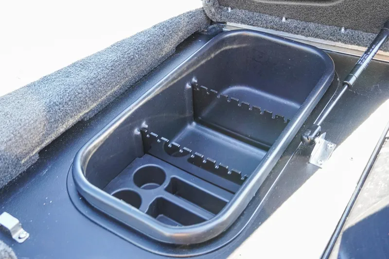 Slide: The Image of 2021 Skeeter FXR20 Apex boat storage compartment with rod holders and cup slots. - 31