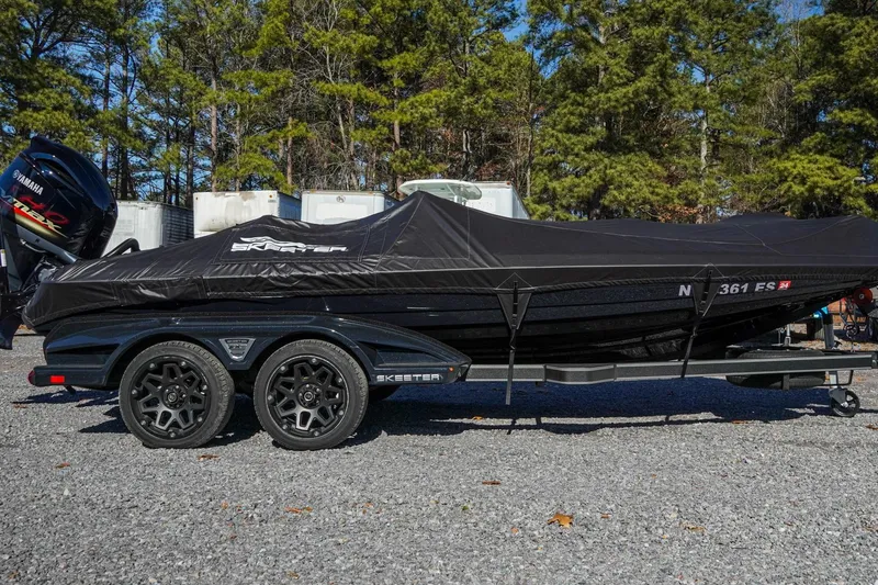 Slide: The Image of 2021 Skeeter FXR20 Apex boat covered on trailer, parked outdoors. - 8