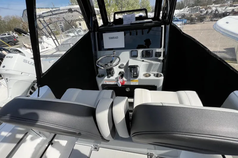 Slide: The Image of 2026 Sea Pro 245FLX Sandbar boat cockpit with steering wheel and controls. - 10