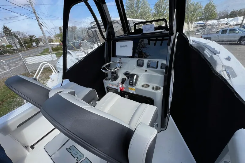 Slide: The Image of Interior view of 2026 Sea Pro 245FLX Sandbar boat, featuring modern helm and seating. - 11