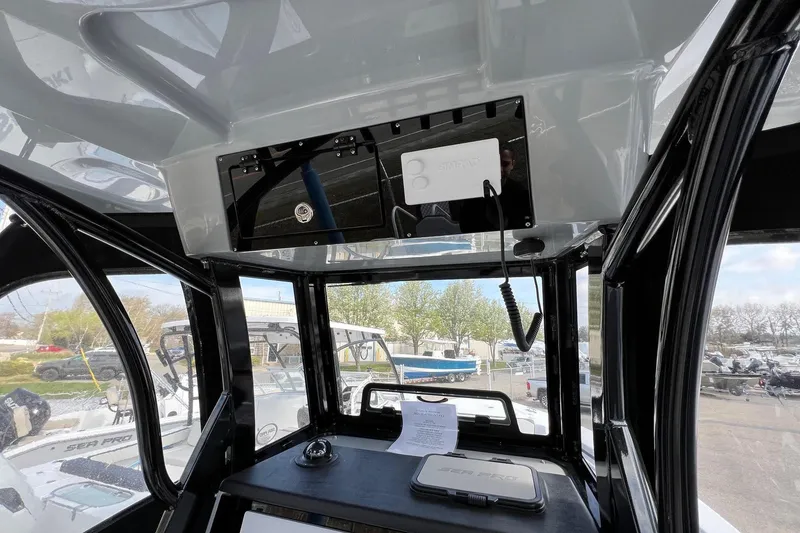 Slide: The Image of Interior view of 2026 Sea Pro 245FLX Sandbar boat with modern dashboard and controls. - 13