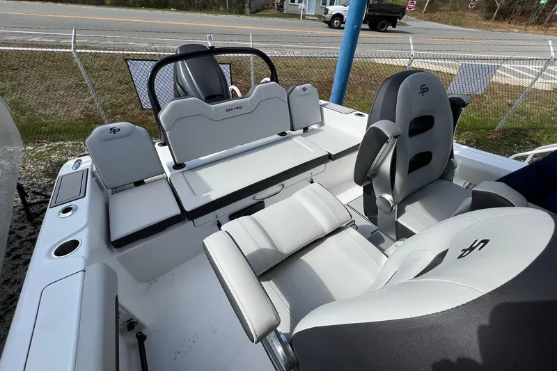 Slide: The Image of 2026 Sea Pro 245FLX Sandbar boat interior with modern seating and steering console. - 15
