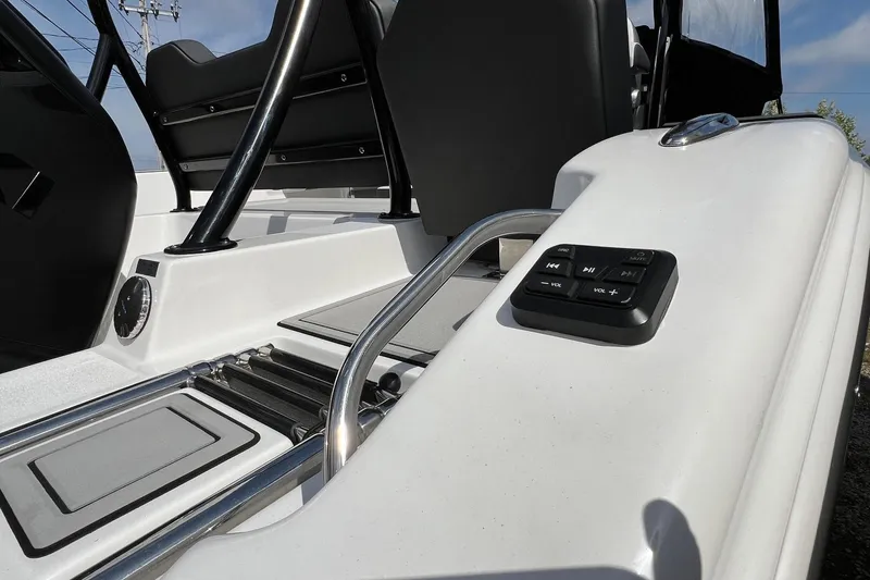 Slide: The Image of 2026 Sea Pro 245FLX Sandbar boat interior with control panel and seating area. - 22