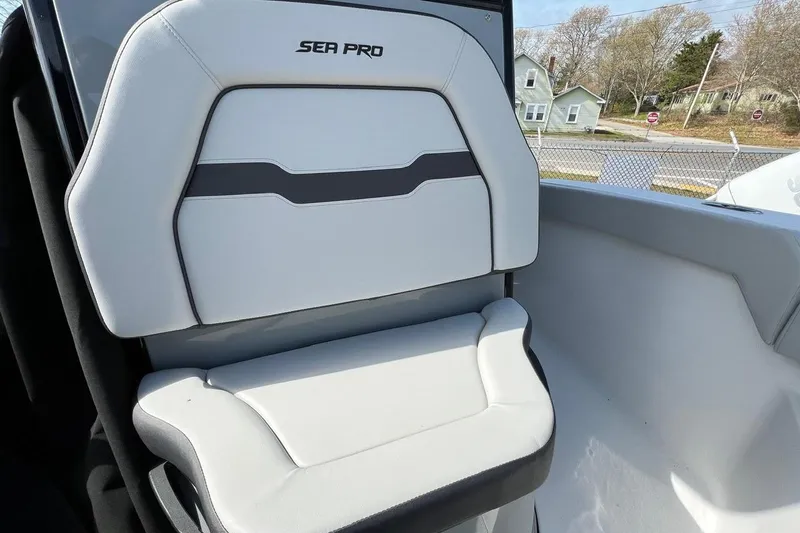 Slide: The Image of 2026 Sea Pro 245FLX Sandbar boat seat, featuring sleek white and gray design. - 23