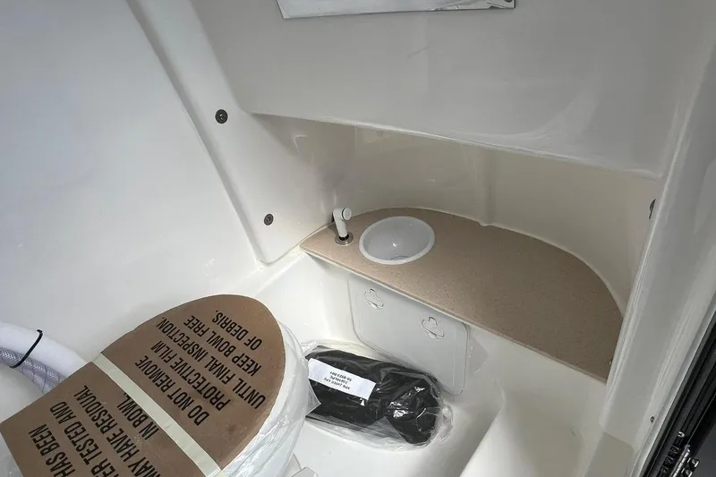 Slide: The Image of Interior of 2026 Sea Pro 245FLX Sandbar boat, featuring compact sink and storage area. - 27