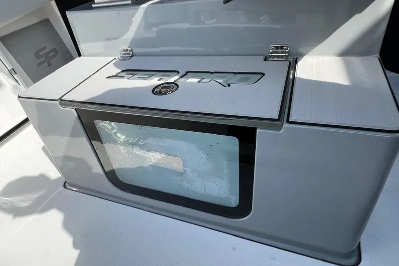 Slide: The Image of 2026 Sea Pro 245FLX Sandbar boat storage compartment with sleek design and logo detailing. - 28