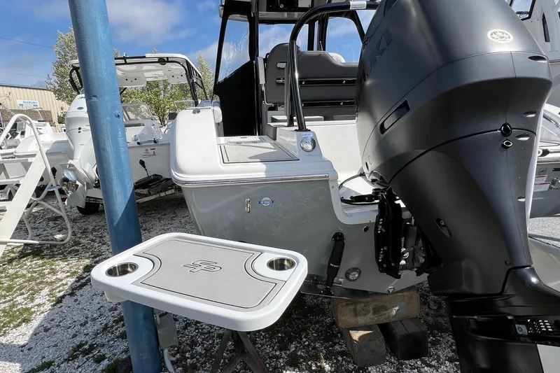 Slide: The Image of 2026 Sea Pro 245FLX Sandbar boat with powerful outboard motor, docked outdoors. - 29
