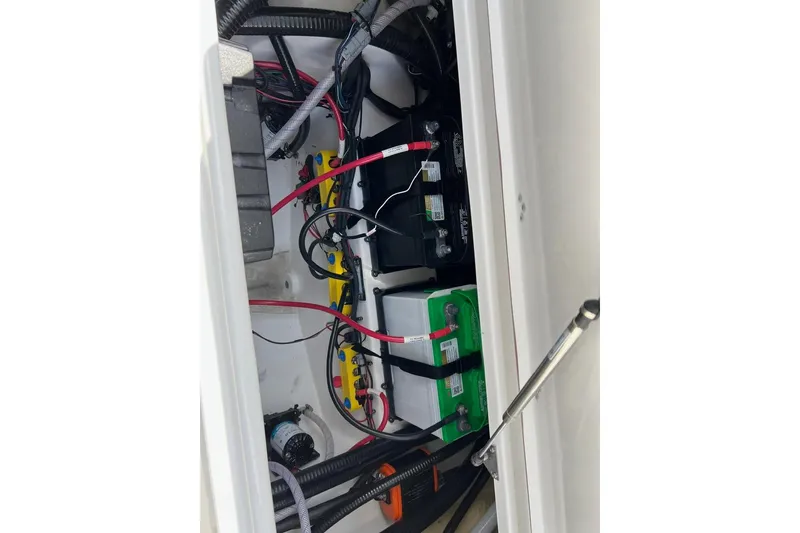 Slide: The Image of Battery compartment of 2026 Sea Pro 245FLX Sandbar boat, showing wiring and connections. - 31