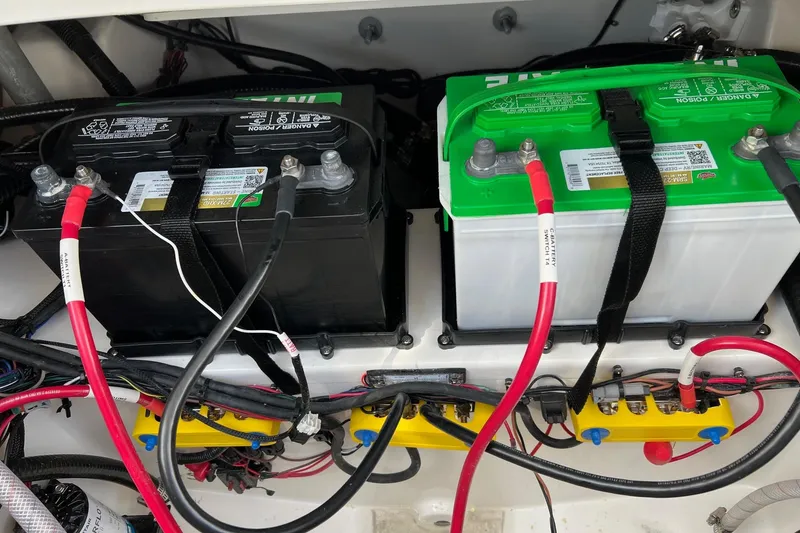 Slide: The Image of Battery compartment of 2026 Sea Pro 245FLX Sandbar boat with wiring and connections. - 33