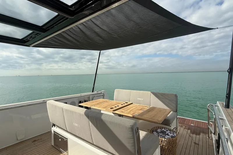 Slide: The Image of Luxurious 2013 Fjord 40' Open yacht with shaded deck and ocean view. - 104