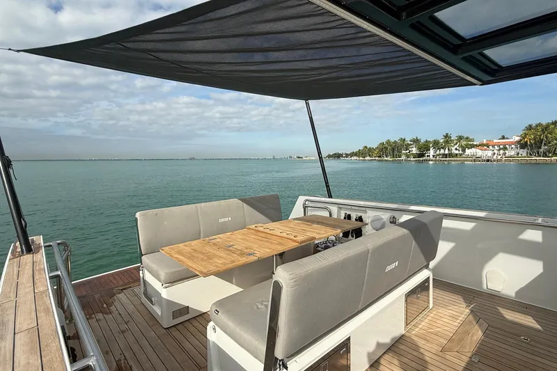 Slide: The Image of 2013 Fjord 40' Open yacht with shaded seating area on calm waters. - 105