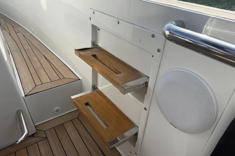 Slide: The Image of Teak steps and speaker on 2013 Fjord 40' Open yacht deck. - 106