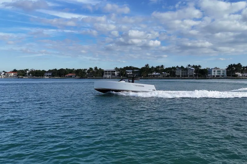 Slide: The Image of 2013 Fjord 40' Open yacht cruising on a sunny day near coastal homes. - 107