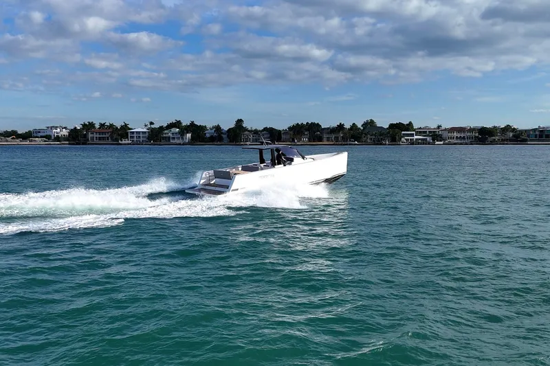 Slide: The Image of 2013 Fjord 40' Open yacht cruising on a sunny day near coastal homes. - 110