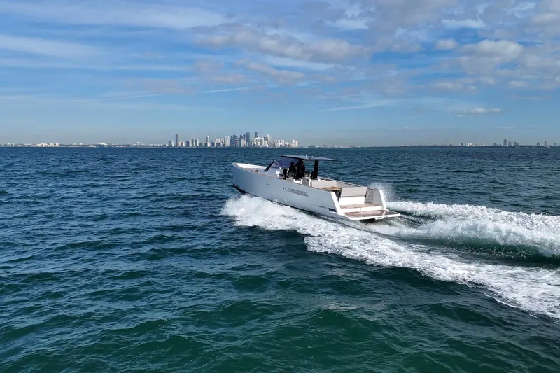 Slide: The Image of 2013 Fjord 40' Open yacht cruising on ocean with city skyline in background. - 114