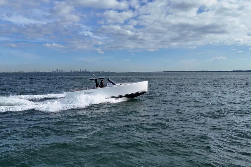 Slide: The Image of 2013 Fjord 40' Open yacht cruising on open water under a partly cloudy sky. - 115