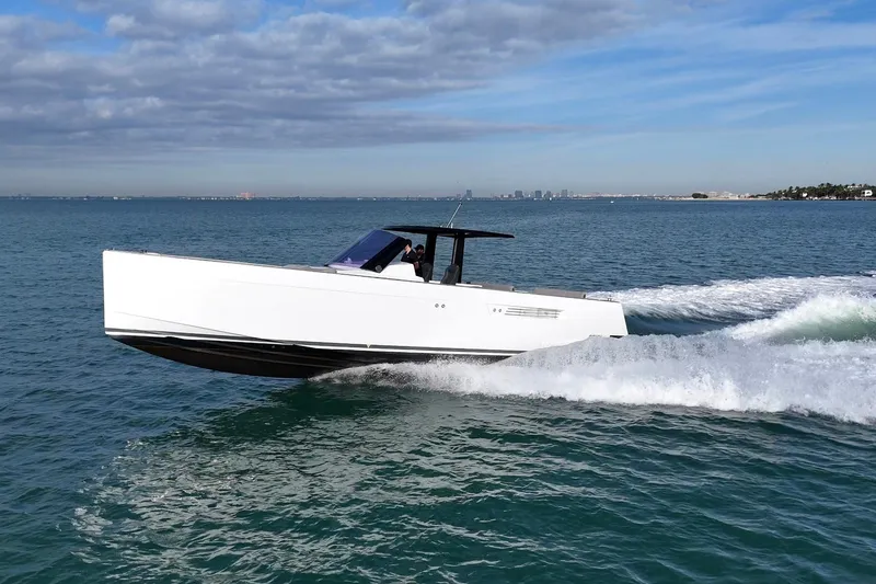 Slide: The Image of 2013 Fjord 40' Open yacht cruising on open water under a partly cloudy sky. - 13