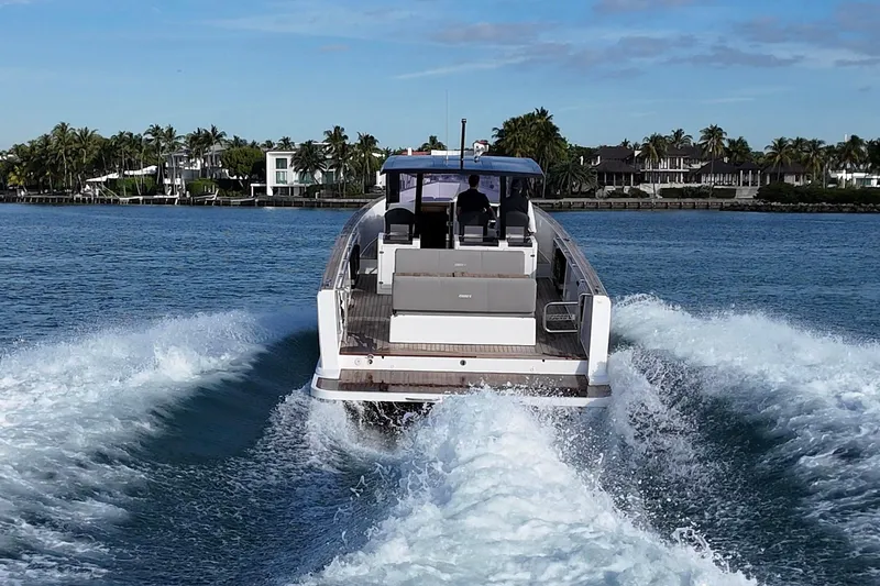 Slide: The Image of 2013 Fjord 40' Open yacht cruising on a sunny day near a tropical shoreline. - 14