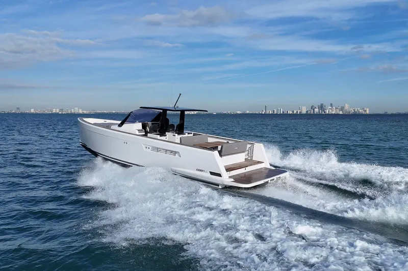 Slide: The Image of 2013 Fjord 40' Open yacht cruising on ocean with city skyline in background. - 16