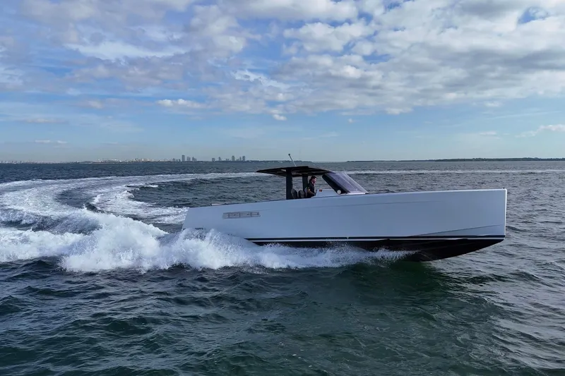 Slide: The Image of 2013 Fjord 40' Open yacht cruising on open water under a partly cloudy sky. - 19