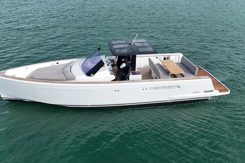 Slide: The Image of 2013 Fjord 40' Open yacht cruising on calm waters, featuring sleek design and spacious deck. - 24