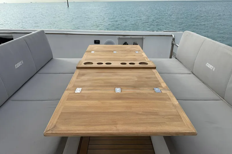 Slide: The Image of Luxury seating area on a 2013 Fjord 40' Open yacht with wooden table. - 29