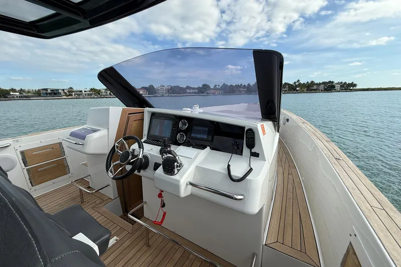 Slide: The Image of 2013 Fjord 40' Open yacht helm with modern controls and scenic ocean view. - 36