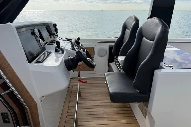 Slide: The Image of Helm of 2013 Fjord 40' Open yacht with dual seats and navigation controls. - 40
