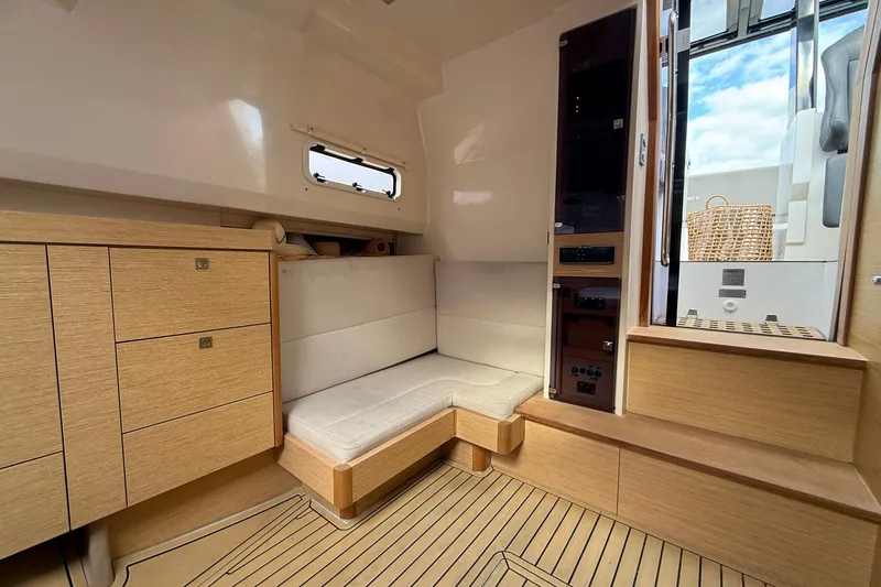 Slide: The Image of Interior of 2013 Fjord 40' Open yacht with wooden cabinetry and cushioned seating. - 42