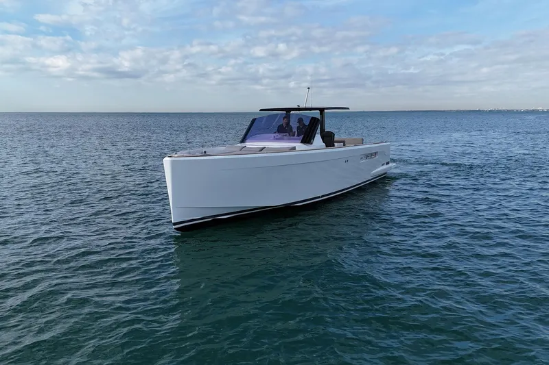 Slide: The Image of 2013 Fjord 40' Open yacht cruising on calm ocean waters under a cloudy sky. - 52