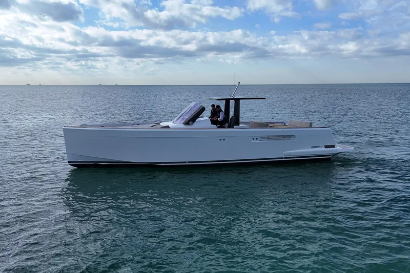 Slide: The Image of 2013 Fjord 40' Open yacht cruising on calm ocean waters under a partly cloudy sky. - 54