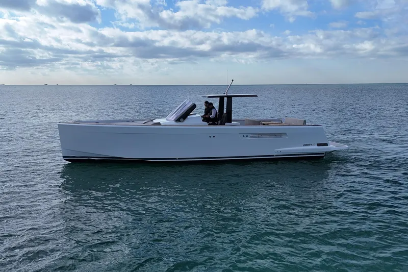 Slide: The Image of 2013 Fjord 40' Open yacht cruising on calm ocean waters under a partly cloudy sky. - 55