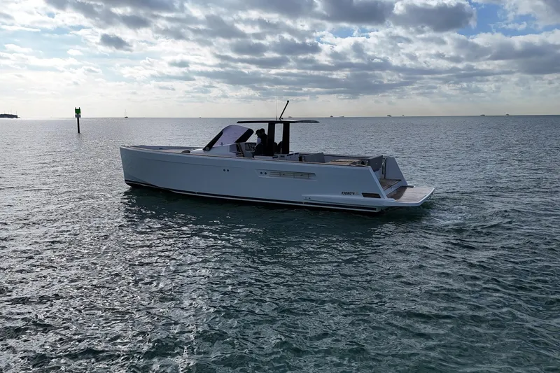 Slide: The Image of 2013 Fjord 40' Open yacht cruising on calm ocean waters under cloudy sky. - 56